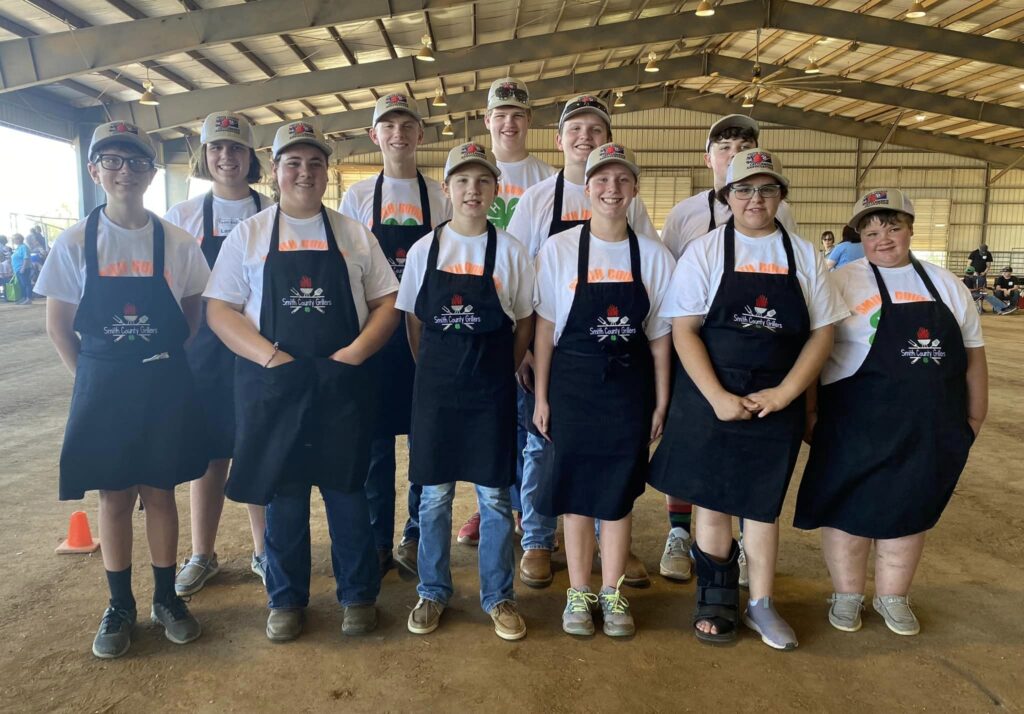 Eleven Smith County 4-H'ers wear matching aprons for the Grill Master Challenge contest