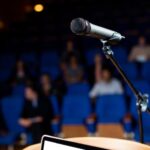 microphone on a podium in front of a crowd